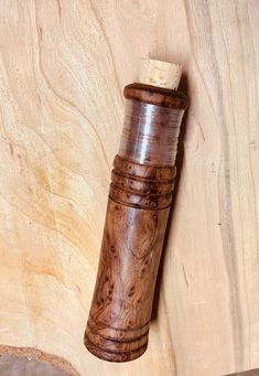 a wooden object with a cork on it