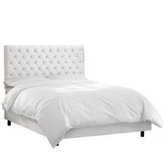 a bed with white linens and buttons on the headboard, in front of a white background