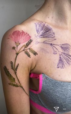 a woman's chest with flowers painted on it