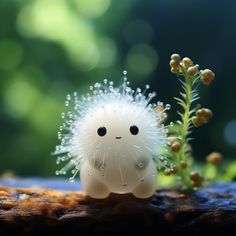 a small white toy sitting on top of a wooden table next to a green plant