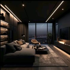 a living room filled with furniture and a large window overlooking the city at night time