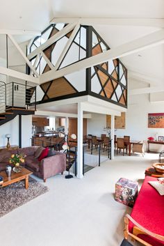 a living room filled with furniture and a spiral staircase