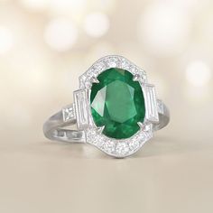 This item has just been reserved by another customer. Please contact us to be notified if it becomes available.  This stunning ring showcases a magnificent oval-cut emerald weighing approx 3.71 carats as its center, delicately held in place by prongs. The emerald is beautifully encircled by a halo of diamonds. On either side of the center stone and along the ring's shoulders, baguette-cut diamonds are accented. The total diamond weight of this ring is approximately 0.60 carats. The platinum sett Green Oval Emerald Ring In Platinum, Exquisite Oval Emerald Ring In Platinum, Luxury Oval Emerald Birthstone Ring, Art Deco Oval Emerald Ring With Brilliant Cut, Classic Oval Tsavorite Ring, Oval Emerald Birthstone Ring In Fine Jewelry Style, Gia Certified Oval Emerald Ring In Art Deco Style, Oval Emerald Ring With Diamond Cut In Platinum, Luxury Oval Emerald Ring With Brilliant Cut