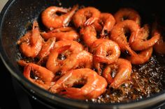 shrimp being cooked in a pan on the stove