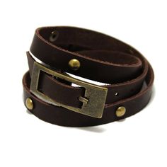 "Narrow stylish leather bracelet in two turns around the arm. Suitable for both girls and guys who like vintage style.  The length of the bracelet is decorated with domed rivets, and the length is regulated by a large buckle, which itself appears as a decorative element.  Made of genuine leather in a single layer with a thickness of about 2 mm.  All bracelet variants are supplied with antique bronze color fittings.  Tech info ----------------- Length: 40-50 cm long (15,5-19,6\") Base width: 11 mm  Thickness: approx. 2 mm   Our other goods -------------------- Aviator cuff bracelet https://www.etsy.com/listing/678376987/aviator-cuff-oldschool-design-double Long strap watch https://www.etsy.com/listing/1013857794/noir-minimalist-quartz-calendar-watches Matte black watch https://www.etsy.com/ Vintage Leather Bracelet With Rivets, Adjustable Brown Leather Bracelet With Brass Hardware, Adjustable Brown Leather Bracelet With Belt Detail, Adjustable Brown Leather Belt Bracelet, Vintage Leather Bracelets With Rivets, Vintage Adjustable Leather Bracelet With Rivets, Adjustable Vintage Leather Bracelet With Rivets, Adjustable Brown Jewelry With Antique Buckle, Leather Wrap Bracelets