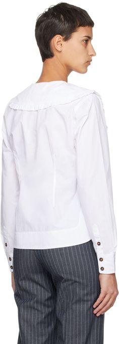 Organic cotton poplin shirt. · Ruffle trim at pointed Peter Pan collar · V-neck · Button closure · Vented side seams · Two-button barrel cuffs Supplier color: Bright white White Poplin Tops With Button Cuffs, White Long Sleeve Poplin Tops, White Button-up Poplin Blouse, Cotton Poplin Shirt, Poplin Shirt, Pan Collar, Peter Pan Collar, Neck Shirt, Ruffle Trim