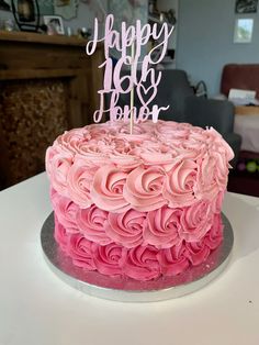 a birthday cake with pink frosting on top