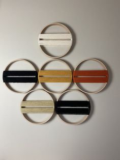 four circular pieces of wood with different colors and designs on the top one is made out of plywood