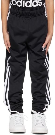 Recycled polyester jersey track pants. · Concealed drawstring at elasticized waistband · Two-pocket styling · Logo embroidered at front · Rib knit cuffs · Stripes at outseams · Machine-wash Supplier color: Black/White Model measures 47” / 119.4 cm tall and wears size XS. adidas Kids Size: child's height XS: 48.5 - 50.5 / 123 - 128 cm S: 53.5 - 55 / 135 - 140 cm M: 58 - 60 / 147 - 152 cm L: 62.5 - 64.5 / 159 - 164 cm XL: 67.5 - 69.5 / 171 - 176 cm Adidas Kids, Kids Black, Knit Cuff, Logo Embroidered, Big Kids, Kids Boys, Kids Clothing, Track Pants, Adidas Originals