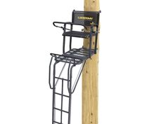 a wooden pole with a ladder attached to it and a black chair on the top