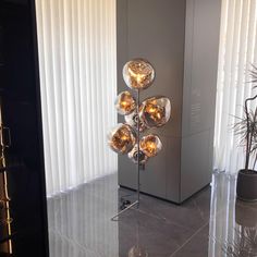 a floor lamp with four glass balls on it