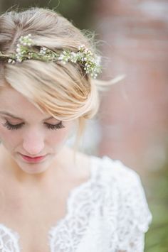 a woman with blonde hair wearing a flower crown