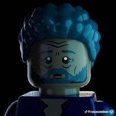 a lego man with blue hair and beard in front of a black background, looking at the camera