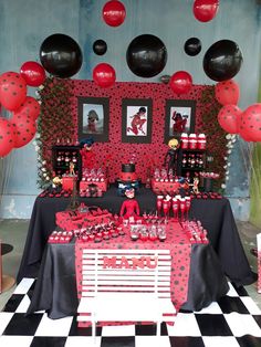 the table is set up with red and black decorations