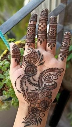 a hand with henna tattoos on it