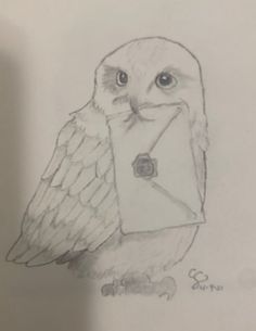 an owl is holding a letter in it's beak