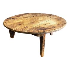 an old wooden table with two legs and a round shape on the top, against a white background