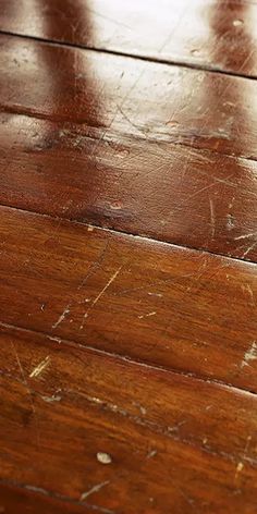 a wooden floor that has been scratched and stained