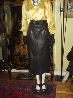 The buttery soft lambskin leather will certainly offer you a wonderful fitting skirt. Condition excellent. No wear scuffs, no cuts or stains. The skirt has its size tag attached, marked as a size 10. Laying the skirt flat on a table, these measurements were taken to help you verify the fit.... Waist....13 3/4 inches across  (27 1/2 inches circumference) Hips...18 inches across  (36 inches circumference) Hem Line....19 1/2 inches (39 inches circumference) Length...32 3/4 inches Both pocket trims are embossed. The front and back inverted pleats have embossed leather inserts. These are not open slits in the skirt. They are 12 inches in height. The belt shown in the photo is not part of the skirt but is available in a separate listing in our shop. Will be pleased to combine shipping to reduce Classic Leather Skirt For Fall, Classic Fitted Leather Skirt, Formal Fitted Leather Skirt, Fitting Skirt, Lambskin Leather, Vintage Leather, Leather Fashion, Embossed Leather, Size Tag