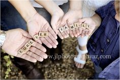 several people holding wooden letters spelling love and family