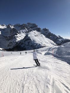 a man riding skis down a snow covered slope