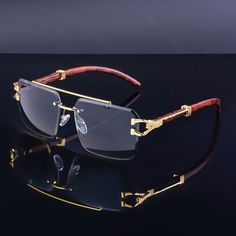 Isabel is pure poetry. Only the best of times will be had with this quirky aviator frame. Artful rimless trimming style and a gold metal temple detail give Isabel its signature look. you've got a style that will be stealing glances all day by just wearing it. Includes adjustable nose pads for a custom fit.Frame Shape: AviatorFrame Color: Gold, BrownFrame Material: Mixed MaterialsLens Color: GrayLens Material: PCRim Type: RimlessLens Width: 56 mmBridge Width: 25 mmTemple Length: 152 mmFrame Width: 128 mmLens Height: 43 mmWeight: 32.5 gUV Protection: UV400Polarized: NoSpring Hinge: NoAdjustable Nose Pads: Yes Mens Spectacles Frames, Cool Glasses For Men, Unique Glasses Frames, Mens Eye Glasses, Gray Sunglasses, Mens Sunglasses Fashion, Mens Glasses Fashion, Man Jewelry, Custom Glasses