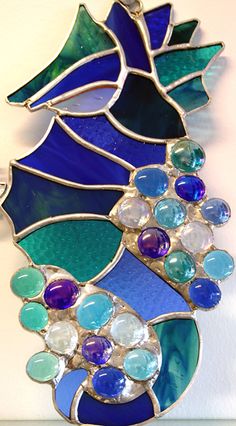 a blue and green stained glass brooch