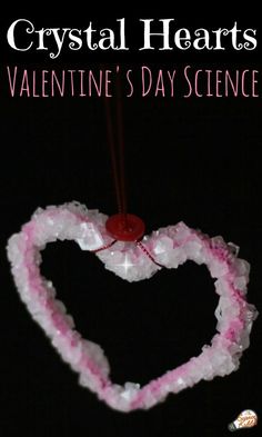 a heart shaped ornament hanging from a string with the words crystal hearts valentine's day science