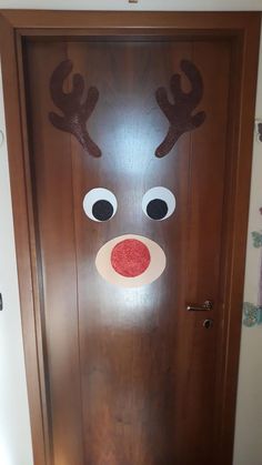 a door decorated with reindeer's head and nose