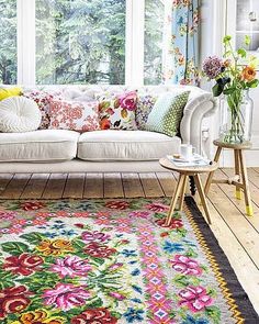 a living room filled with furniture and flowers