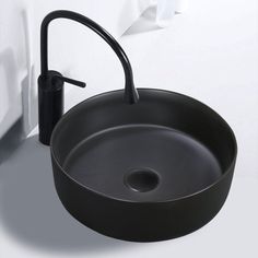 a black sink sitting on top of a white counter