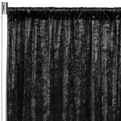 a black curtain is hanging on the wall