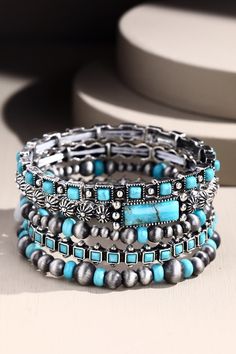 This stunning boho bracelet is so unique and cool, Tawny Stone Bracelet Set Set will set your wrists apart and keep you shining all day long! Cute set of 5 western-style stretch bracelets Semi-natural stone details inspired by turquoise Gorgeous western-style stretch bracelets Unique embossed metal designs throughout Wear them separately or together for the perfect boho touch! *Due to lighting and differences in monitors, actual colors may vary slightly from what appears online. Model is 5'8" an Stackable Turquoise Jewelry For Festivals, Turquoise Stackable Bracelets For Festivals, Bohemian Stackable Beaded Bracelets In Turquoise, Stackable Bohemian Turquoise Beaded Bracelets, Bohemian Turquoise Stackable Beaded Bracelets, Bohemian Turquoise Stackable Wrap Bracelet, Turquoise Bohemian Stackable Wrap Bracelet, Bohemian Turquoise Stretch Bracelet For Festivals, Bohemian Stackable Stretch Bracelet For Festivals