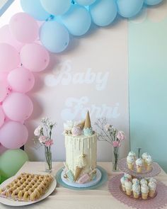 a baby shower party with cake, waffles and balloons