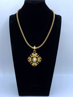 "This is a rare Monet necklace by Christian Lacroix. This Monet pendant necklace is a vintage Monet Maltese pendant and necklace that is featured in the \"Monet the Master Jewelers\" book by Alice Vega on page 283. This pendant was under license from Christian Lacroix in 1995. The pendant has pearl cabochons, dark red cabochons and black enamel on a matte gold tone. The piece is not signed Christian Lacroix, the licensed series were signed by Monet. The gold tone chain necklace is in mint condition but notice the dip in enameling on the pendant shown in the last photo. The velvet gift box is included in the purchase. Rare Monet Necklace By Christian Lacroix Monet Pendant Necklace Signed Monet, Monet Jewelry, Vintage Monet Pendant Please see the photos and don't hesitate to contact me to as Monet Jewelry, Vintage Monet, Christian Lacroix, Jewelry Vintage, Matte Gold, Black Enamel, Maltese, Bling Bling, Dark Red