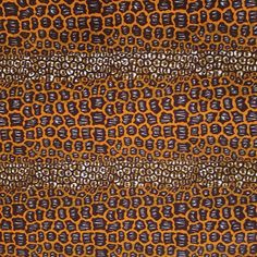 an orange and black pattern on fabric