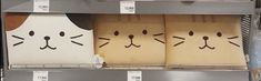 some boxes with faces drawn on them in a store