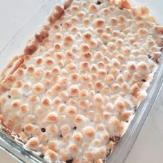 a casserole dish filled with marshmallows on top of a table