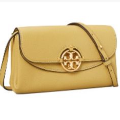 Tory Burch Miller Wallet Crossbody Signature Metal Double “T “. A Striking Expression Of Workmanship And Artistry. Artisanal Stitching. Natural-Grain Leather Adjustable Strap And A Gusseted Shape That Opens To Multiple Compartments Including A Zippered Pocket That Fits A Phone. Stunning Muted Yellow Color Will Give Your Wardrobe A Pop Of Color. Tuck The Strap Down And You Have A Gorgeous Evening Clutch. Features: Napa Pebbled Leather Brass-Finish Hardware; Stitching Throughout Pin-Snap Closure A Travel Wallet With Gold-tone Hardware, Tan Clutch Shoulder Bag For Travel, Classic Gold Crossbody Wallet, Tan Leather Wallet On Chain, Gold Crossbody Travel Wallets, Tan Leather Wallet On Chain For Everyday Use, Classic Tan Wallet On Chain For Everyday Use, Tory Burch Crossbody Bag, Muted Yellow