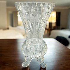 a glass vase sitting on top of a wooden table