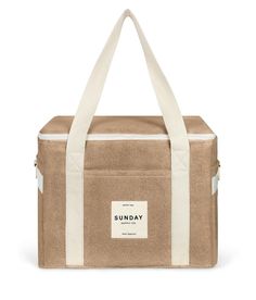 the sunday lunch bag in tan and white is shown from the front, with an open zipper