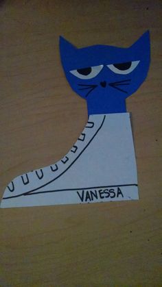 a paper cut out of a shoe with a blue cat's face on it