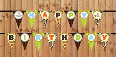 a happy birthday banner with giraffes and ice cream cones hanging on a wooden fence