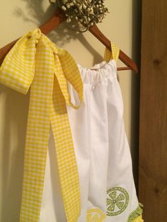 Lemonade Summer Party Dress with a lovely gingham yellow fabric bow on adjustable neckline, appliquéd lemons , limes and oranges on front and back. Green and yellow country ruffle just above hem. So cute for a lemonade theme birthday party or even your local summer lemonade stand This dress is a One of a kind and very versatile. Length of dress from gathered neckline to hem is 21 1/2 inches long. Armhole area is 5 inches long and of course the gingham yellow bow sets on shoulder. Full width at h Spring Picnic Dress With Bow, Cotton Dress With Bow Tie Back For Brunch, Cotton Lemon Print Dress For Garden Party, Cotton Dress With Bow Tie Back For Garden Party, Yellow Cotton Dress For Picnic, Yellow Spring Dress With Bow, Preppy Cotton Dress For Picnic, Cute Yellow Dress For Picnic, Gingham Cotton Dress For Garden Party