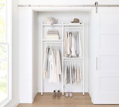 a white closet filled with clothes and shoes