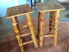 two wooden stools sitting next to each other on top of a carpeted floor