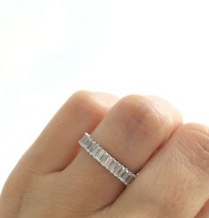 a woman's hand with a diamond ring on it