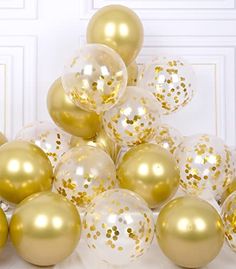 gold and white balloons with confetti on them