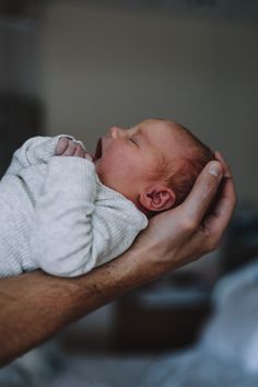 a man holding a baby in his hands