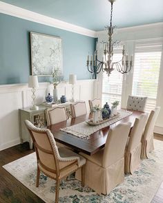 a dining room table with chairs and a chandelier